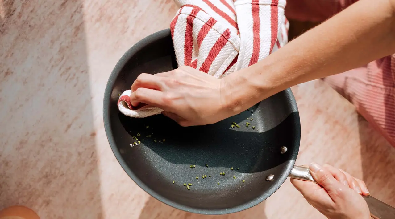 Why black residue forms on nonstick pans