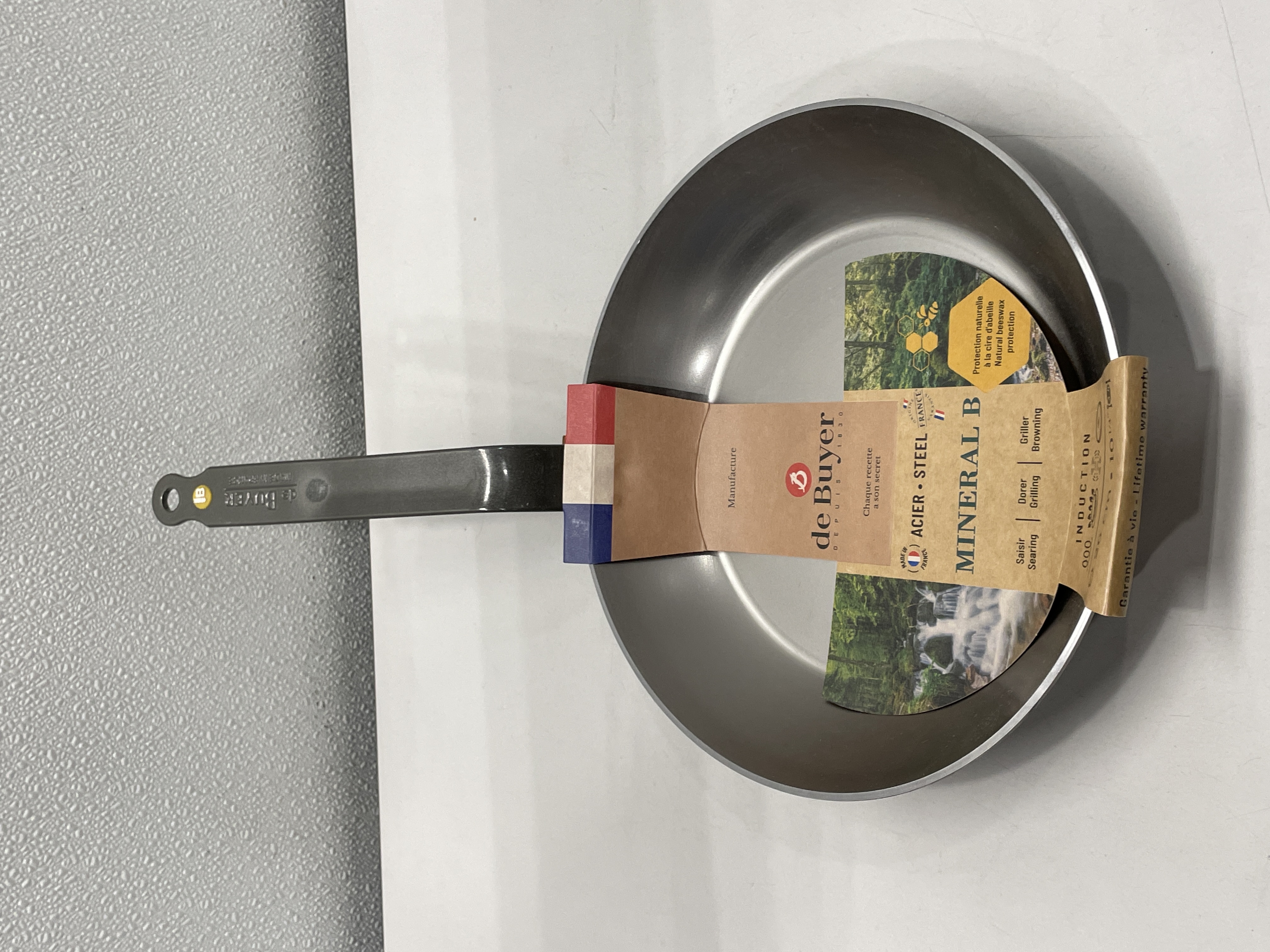 Which cookware brands offer lifetime warranties on their products?